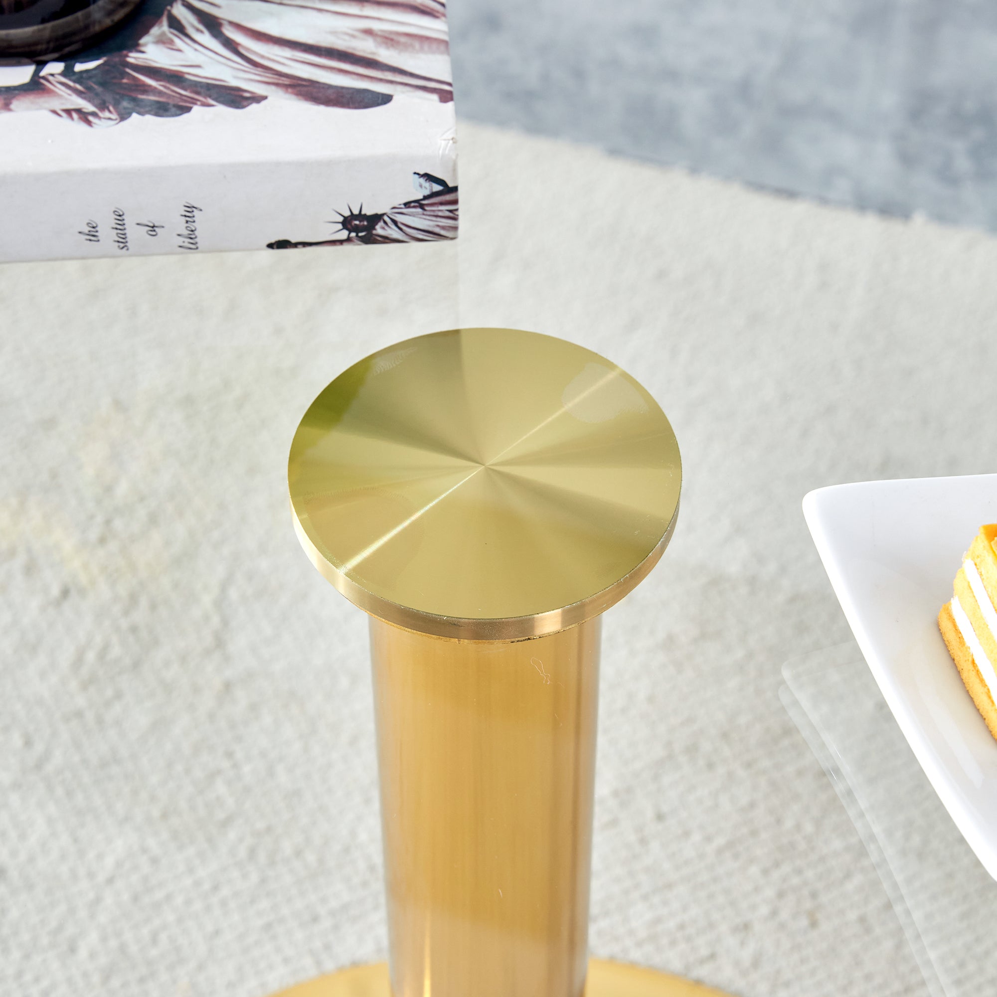 A 35-inch diameter glass top and a modern, minimalist round dining table with gold metal legs. Ideal for dining rooms, living rooms and meeting rooms.W1151P263755